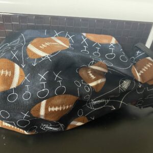 Football face mask a face mask with footballs and game plays on it. #football