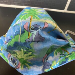 Stitch Face Mask - A Hawaiian theme with Stitch and palm trees on the face mask. #Stitch