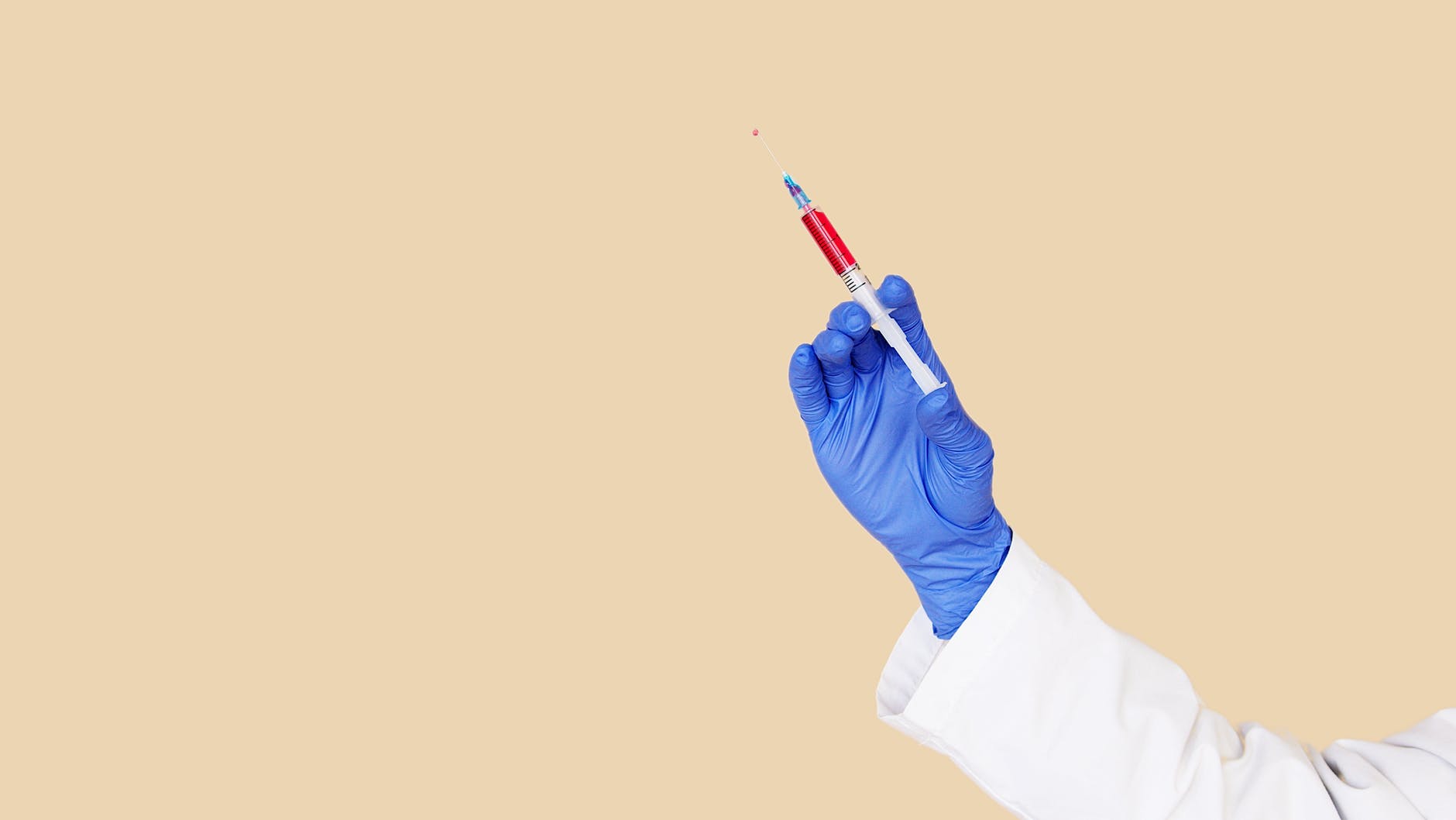 crop doctor in white uniform and blue gloves with syringe Tennessee Selected for Pfizer COVID-19 Vaccine Distribution Pilot Program, Tennessee, Pfizer, Pfizer COVID-19 Vaccine, COVID-19 Vaccine, 