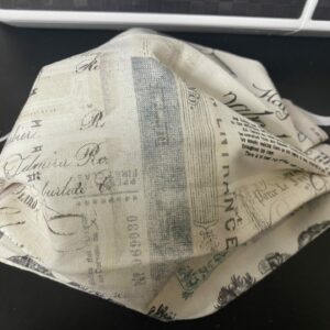 Vintage Text Face Mask - a face mask with a collage of clippings of old sketches, black and white prints and vintage calligraphy.