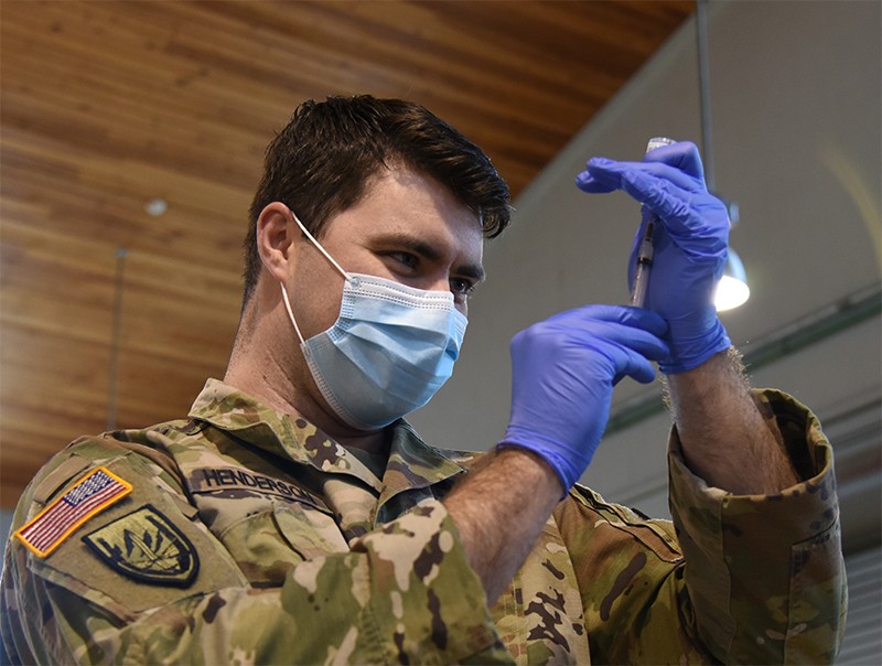 Tennessee National Guard continues COVID-19 testing and vaccinations - Sgt. Dillon Henderson with Smyrna’s 208th Medical Company prepares to administer the Moderna vaccine at Smyrna’s Volunteer Training Site on Jan. 28. (photo by Sgt. 1st Class Edgar Castro)  
