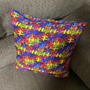 Autism Awareness Decorative Pillow - A decorative pillow with colorful puzzle pieces on it. #Autism #AutismPillow #AutismAwareness