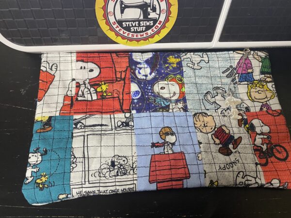 Quilted Snoopy Zipper Pouch - this is for a custom snoopy zipper pouch, the pouch is made up of a variety of Snoopy fabric and quilted. It also includes a Snoopy Zipper Pull. #Quilt #Snoopy