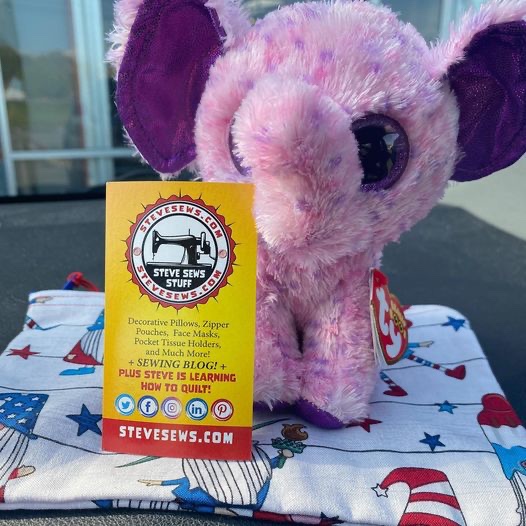 Eva the Elephant showing off a 4th of July Gnome Zipper Pouch