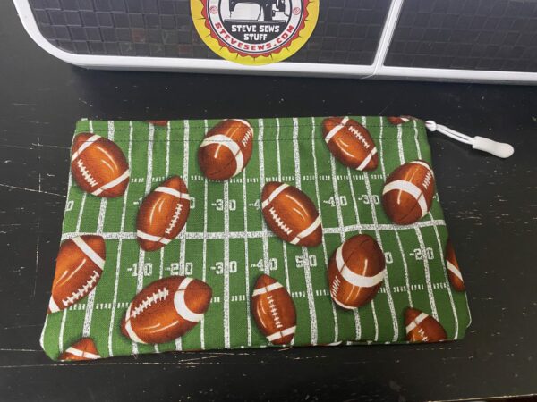 Football Zipper Pouch - This zipper pouch has a football field and a bunch of footballs on it. Great for anyone who loves football. #Football #footballfield