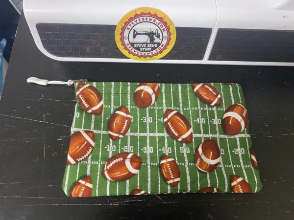 Football Zipper Pouch - This zipper pouch has a football field and a bunch of footballs on it. Great for anyone who loves football. #Football #footballfield