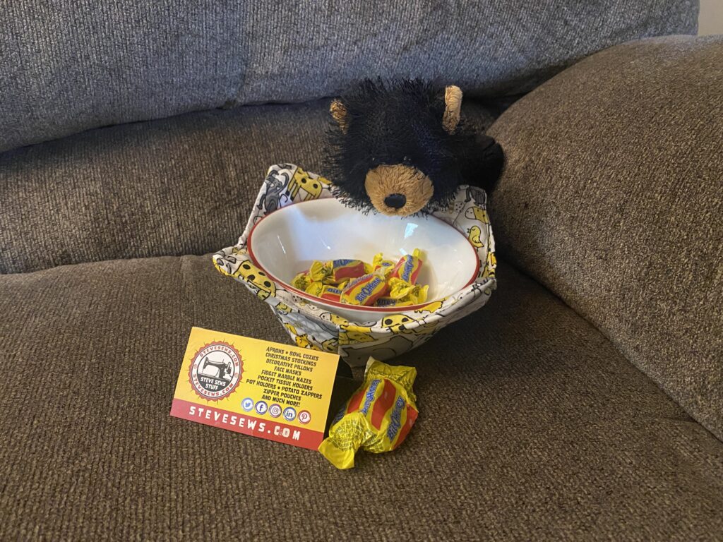 Meet Boogie Woogie - He is a Webkinz Bear and he is our official product tester. He is showing off the Zoo Animals Bowl Cozy while enjoying a smackerel of honey … umm Bit-O-Honey candies that is. #Webkinz
