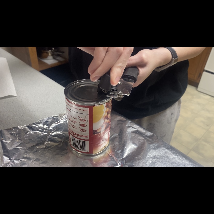 Opening a Can with a can opener instead of doing the normal way you can open it from the side too! 