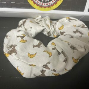The Cow Jumped Over the Moon Scrunchie is a Scrunchie with cows and moons on it. Read more: https://stevesews.com/product/cow-jumped-over-the-moon-scrunchie/