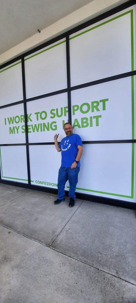 I work to support my sewing habit - Steve stops to pose with this window at the JoAnn’s in Knoxville, TN two different times. #sewinghabit #joannstore #joannfabrics